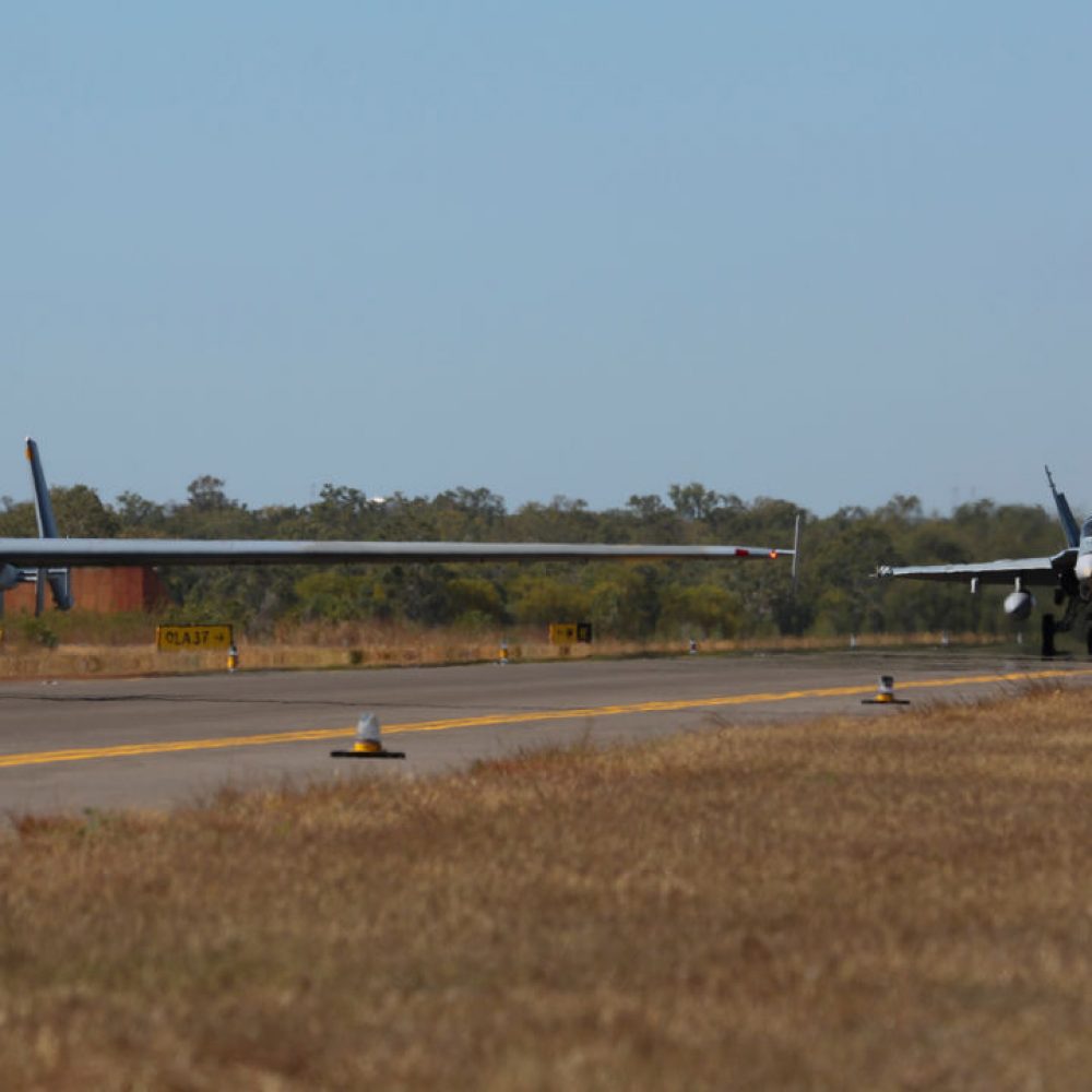 Two Royal Australian Air Force F/A-18 Hornets follow the Heron Remotely Piloted Aircraft  along the RAAF Tindal taxiway, commencing their missions during Exercise Diamond Storm 2017. *** Local Caption *** Exercise Diamond Storm, run by the Air Warfare Centre, is one of the practical components of the Air Warfare Instructors Course which graduates students who are experts in Australian Defence Force capabilities and integration across the services, and also have technical mastery of their own roles, capabilities and systems.